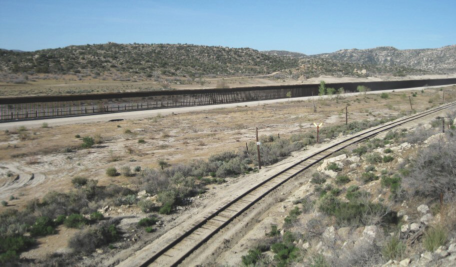 The border wall between the U.S. And Mexico across an arid landscape.