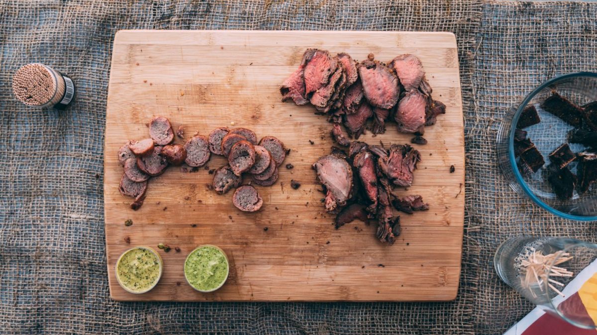 Venison sausage, tenderloin and jerky samples on a cutting board