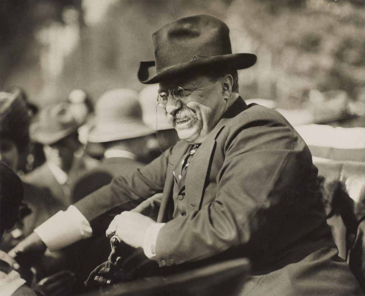 Teddy Roosevelt smiling in a crowd of people